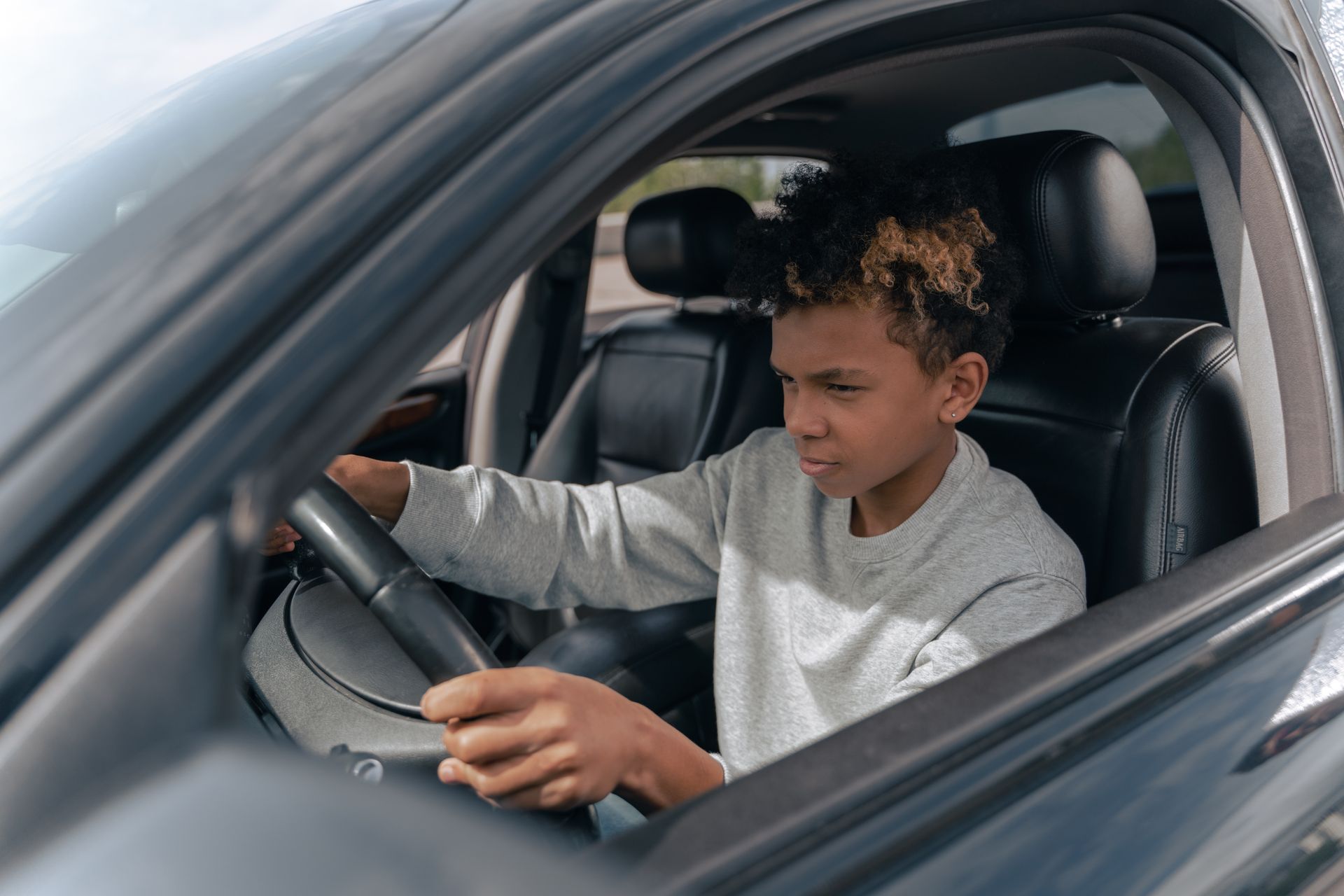 Driving instructor and learner inside a car